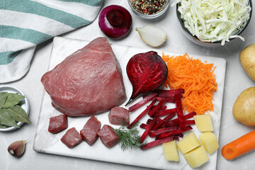 Fresh ingredients for borscht on light grey table, flat lay