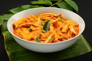 Homeade traditional anchovy fish curry with coconut and mango - Kerala food recipes background