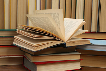 Many hardcover books as background, closeup. Library material - obrazy, fototapety, plakaty