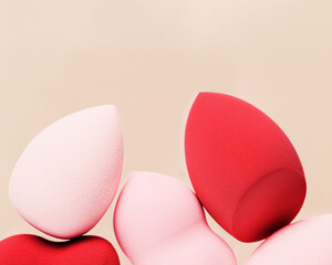 Red and pink cosmetic beauty sponges close up Makeup puff Top view