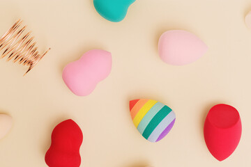 Flat lay colorful cosmetic beauty sponges close up different form. Makeup tool for applying products