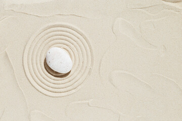 Fototapeta na wymiar Aesthetic minimal background with zen stone on sand. Pattern in Japanese Zen Garden