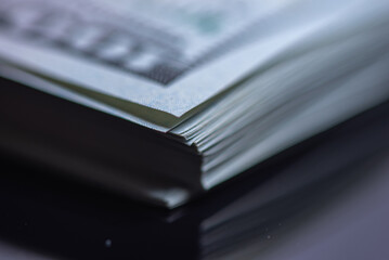 Stack of one hundred American dollars banknotes, close-up.