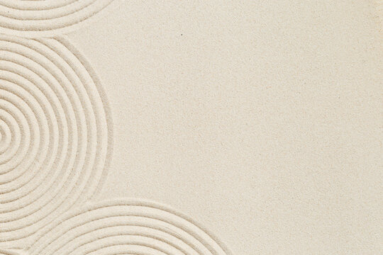Lines drawing on sand, beautiful sandy texture. Spa background, concept for meditation and relaxation