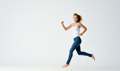 Fototapeta na wymiar woman in jeans movement dance energy positive fashion