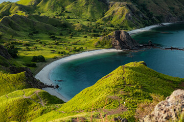 One of the turquoise bays of Padar island with white sand