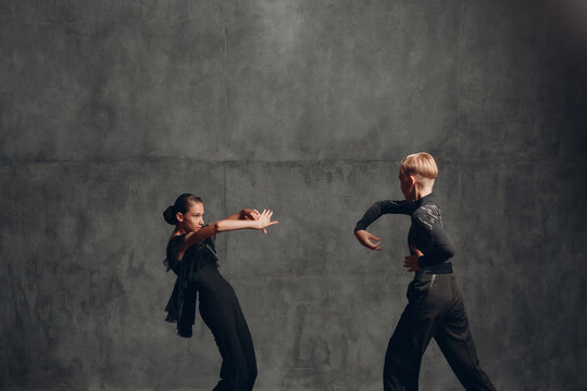 Young couple dancing in ballroom dance Paso doble.