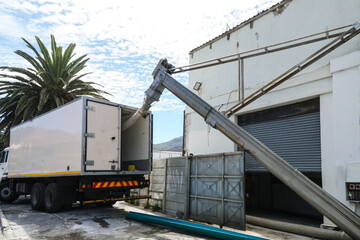 reefer truck or refrigerated truck parked outside building with maintenance equipment for...
