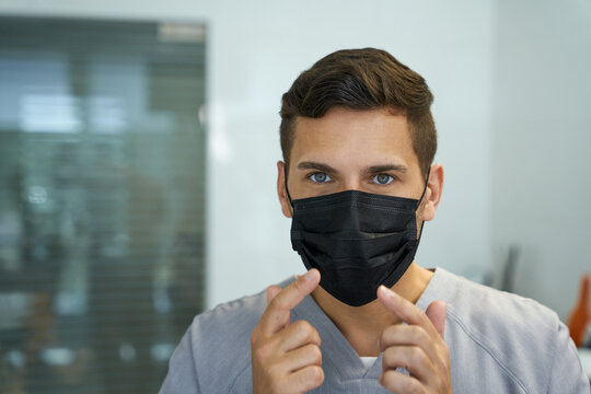 Mindful Doctor Showing A Correct Way To Wear A Mask