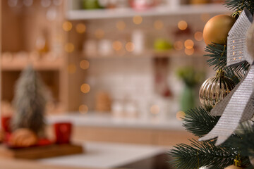 Happy New Year and Merry Christmas! Christmas tree decorated with Christmas tree decorations. Christmas kitchen. Beautiful bokeh in the background.Copy space for text