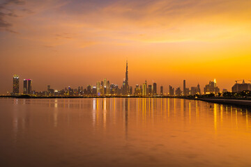 Fototapeta premium Dubai city skyline at night with a colorful sky and reflection on the water. A view from Al Jaddaf, Dubai, UAE.