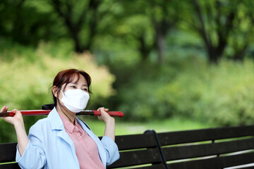 Korean woman practicing kendo in a hi-dong kendo pose with a sword.