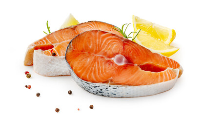 Salmon steaks with rosemary and lemon on white background. Salmon pieces with lemon slices and spices isolated.