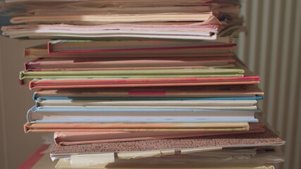 The use of books in the educational process. Paper textbooks are stacked. Pending use. Camera movement, sunlight.
