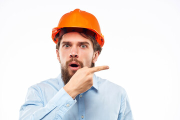emotional man orange helmet on the head Studio hand gesture