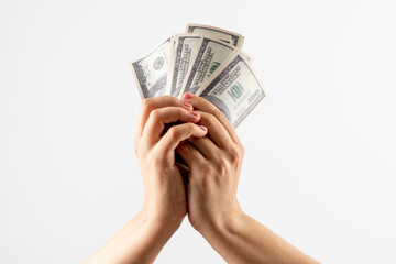 hands raise dollars on a white background. Hands holding money  - money raising, funding and consumerism concept