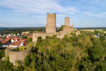 Fototapeta na wymiar Ruin of medieval Münzenberg castle in Hesse, Germany. Built in 12th century, one of the best preserved castles from the High Middle Ages in Germany. Summer, sunset light, aerial view