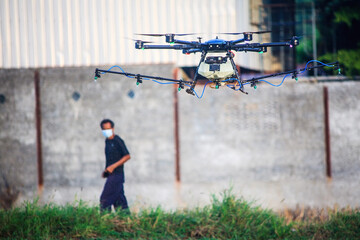 man looking for agriculture drones spray chemicals on the fields