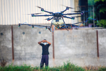 man looking for agriculture drones spray chemicals on the fields