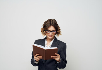 Businesswoman with a book in his hands light background