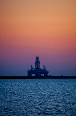 Oil rig at sunset