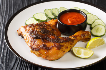 Ayam Bakar is a dish of charcoal-grilled chicken marinated in kecap manis, coconut oil, shallot, garlic, chilli pepper, coriander, tamarind juice, candlenut, turmeric and galangal closeup
