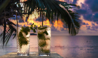 drinks with blur tropical background - obrazy, fototapety, plakaty