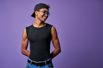 Portrait of transgender male in black t-shirt and blue jeans. Latino trans gender model posing - obrazy, fototapety, plakaty
