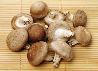 Shiitake mushrooms on the wooden background. 