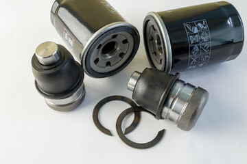 ball joint and oil filter on a white background. new spare parts of the car. elements of automobile...
