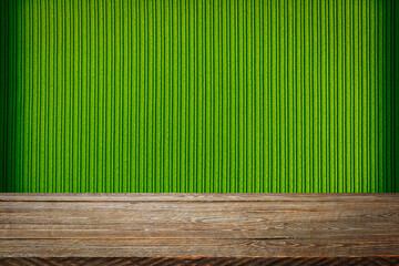The background is blank wooden boards and a textured striped wall with gradient lighting and...