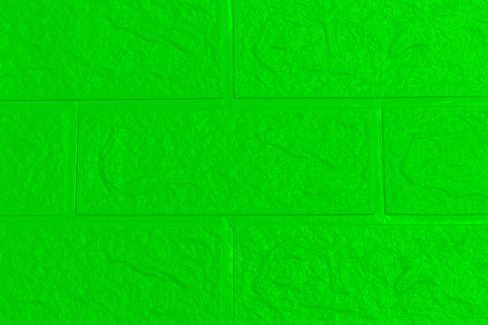 The green  wallpaper texture has an abstract roughness and brick wall pattern for the background.