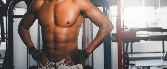 Portrait of Black muscular male athlete workout in fitness gym