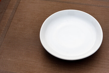Empty white dish on dinning table, for ready to eat