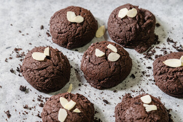 Homemade Chocolate Brownie cookies and almond slide on with papers for baking