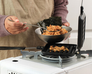 Female Asian Chef Making Waffle Kimchi Fried Rice (Kimchi Bokkeumbap) or Nasi Goreng Waffle, Trendy Viral Rice Pressed Using Waflle Maker, Popular in South Korea