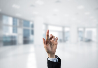 Choosing gesture of businessperson in elegant modern interior in sunshine light