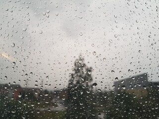 Raindrops run down the window pane