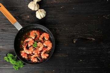 Top View Gambas al aJillo. Shrimp Scampi on a Skillet. Traditional Spanish Tapa with Prawns Cooked...