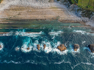 Fototapeta na wymiar Dramatic view of Playa de la Arnia, rocky coastline in Santander ,Cantabria, Spain