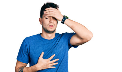 Young hispanic man wearing casual t shirt touching forehead for illness and fever, flu and cold, virus sick