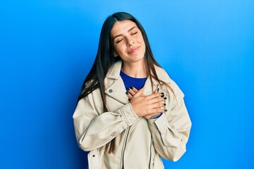 Young hispanic woman wearing casual leather jacket smiling with hands on chest, eyes closed with grateful gesture on face. health concept.