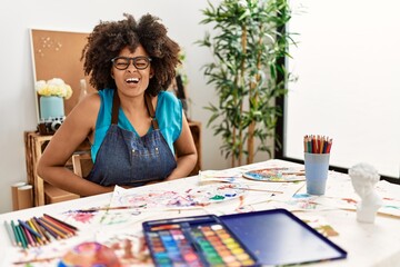 Fototapeta premium Beautiful african american woman with afro hair painting at art studio with hand on stomach because nausea, painful disease feeling unwell. ache concept.