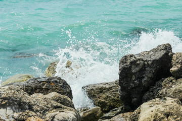 Waves crash on stones