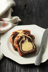 Loaf Marble Cake Slice on Black Wooden Background
