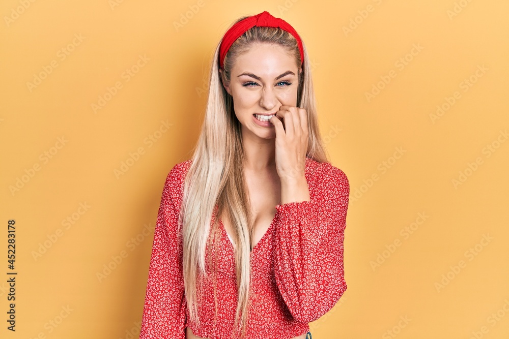 Sticker Young beautiful caucasian woman wearing summer dress looking stressed and nervous with hands on mouth biting nails. anxiety problem.