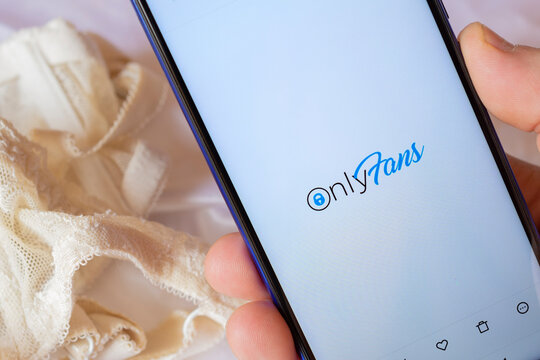 Smatphone with a lace bra on the background, shows the Onlyfans logo. Onlyfans