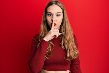 Young blonde woman wearing turtleneck sweater asking to be quiet with finger on lips. silence and secret concept.