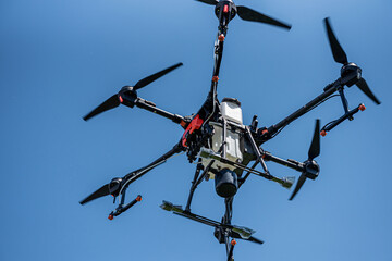 Professional agriculture drone flying in the blue sky
