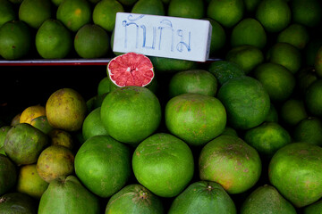 heap of pomelo citrus fruit for sale at retail